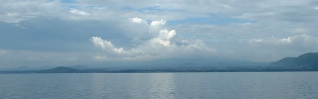 Lake Kivu on a calm day, overlooking the volcano